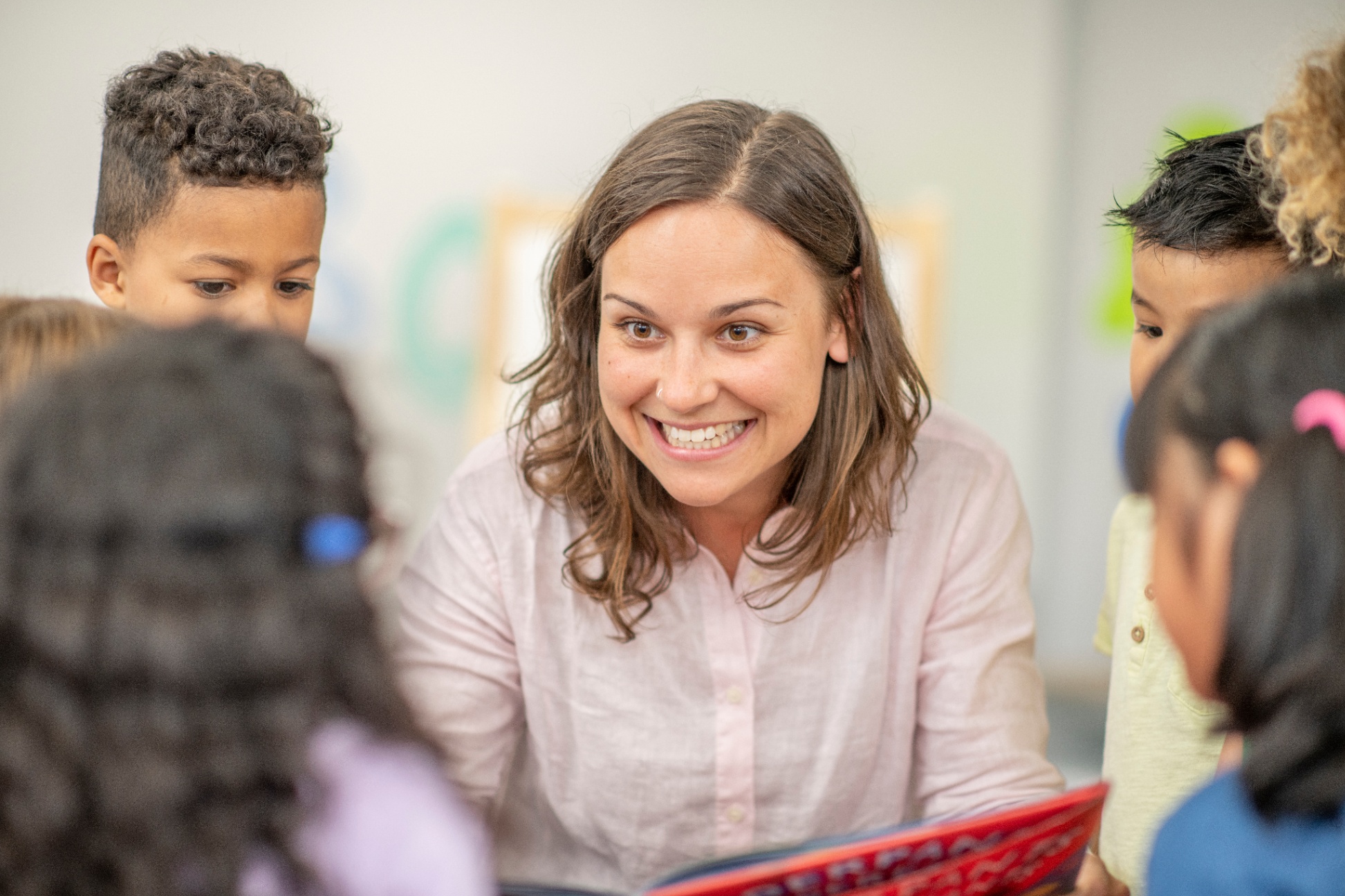 A teacher reading to a group of elementary students