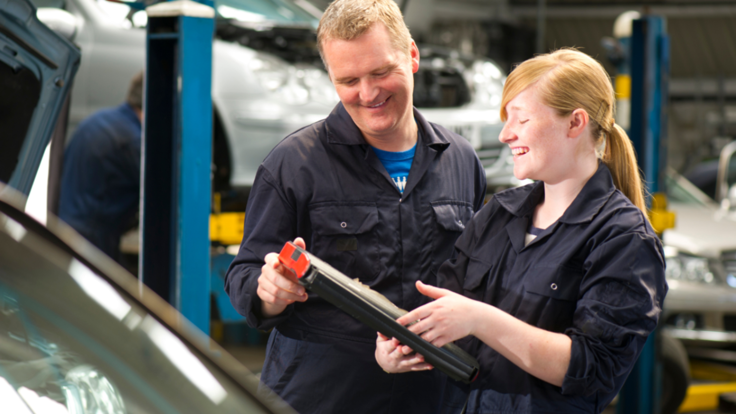 An adult and student work together in a mechanic learning setting